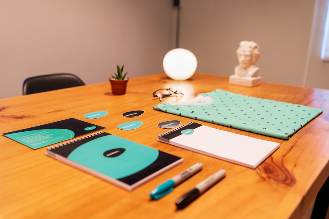 blue-and-black-click-pen-on-brown-wooden-table-y1efzwi1xyu